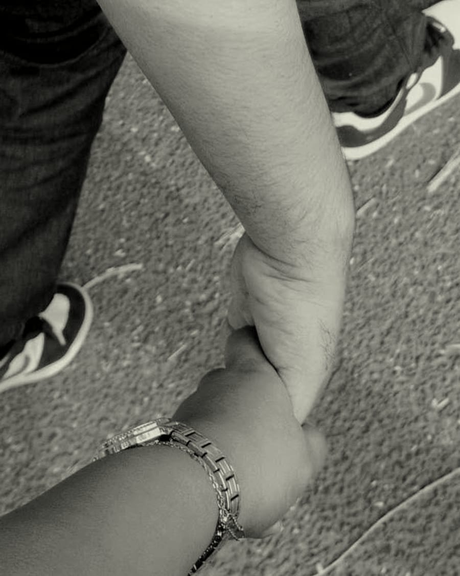 Rachel and Praduan holding hands as they walk