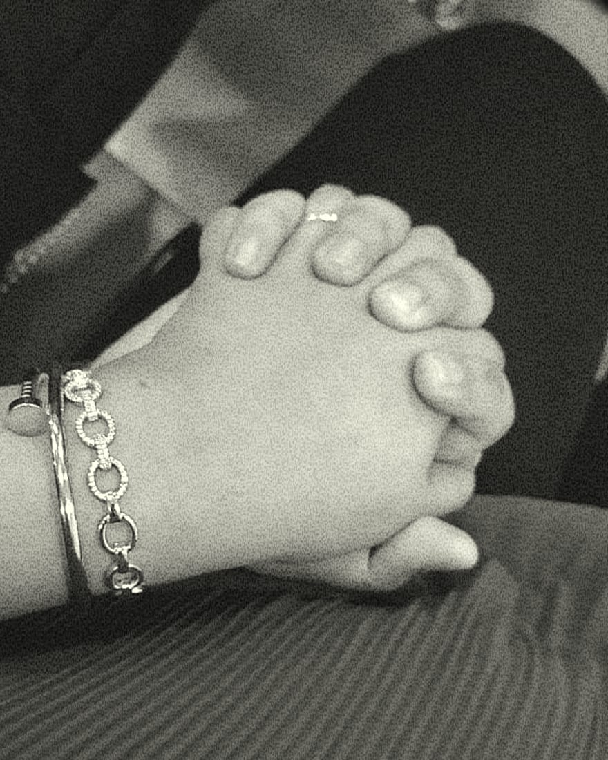 Rachel and Praduan’s hands clasped together